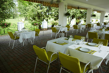 Image showing terrace summer cafe with tables and chairs for people, an empty institution for recreation, nobody