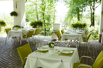 Image showing terrace summer cafe with tables and chairs for people, an empty institution for recreation, nobody