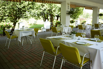 Image showing terrace summer cafe with tables and chairs for people, an empty institution for recreation, nobody