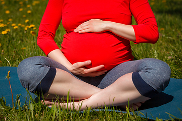 Image showing Pregnant woman doing asana Sukhasana outdoors