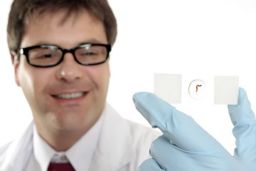 Image showing Smiling lab worker with slide