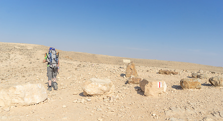 Image showing Hiking tourist in desert trek adventure