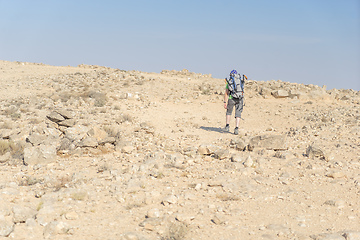 Image showing Hiking tourist in desert trek adventure