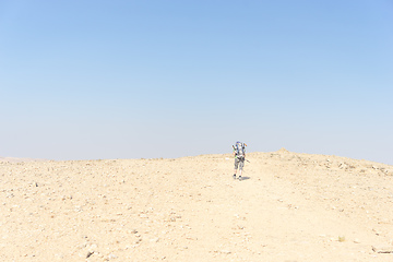 Image showing Hiking tourist in desert trek adventure