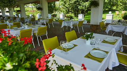 Image showing terrace summer cafe with tables and chairs for people, an empty institution for recreation, nobody