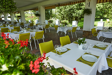 Image showing terrace summer cafe with tables and chairs for people, an empty institution for recreation, nobody