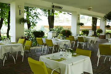 Image showing terrace summer cafe with tables and chairs for people, an empty institution for recreation, nobody