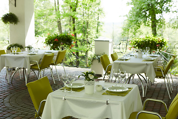 Image showing terrace summer cafe with tables and chairs for people, an empty institution for recreation, nobody