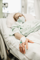 Image showing Focus on the woman hand of a patient with medical drip or IV drip in hospital ward , health and medical care concept.