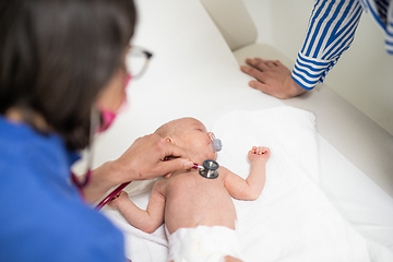 Image showing Baby lying on his back as his doctor examines him during a standard medical checkup