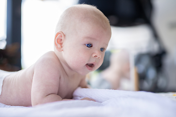 Image showing Cute caucasian baby boy lying on stomach.