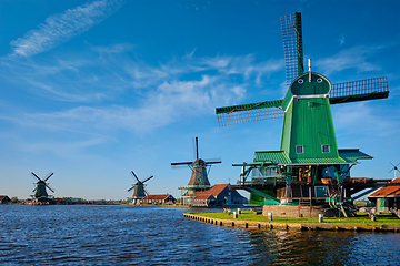 Image showing Windmills at Zaanse Schans in Holland on sunset. Zaandam, Netherlands