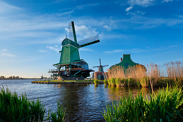 Image showing Windmills at Zaanse Schans in Holland on sunset. Zaandam, Netherlands