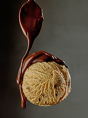 Image showing melted chocolate pouring on ice cream ball