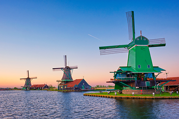 Image showing Windmills at Zaanse Schans in Holland on sunset. Zaandam, Netherlands