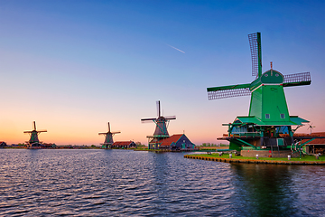 Image showing Windmills at Zaanse Schans in Holland on sunset. Zaandam, Netherlands