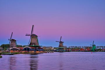 Image showing Windmills at Zaanse Schans in Holland in twilight on sunset. Zaa