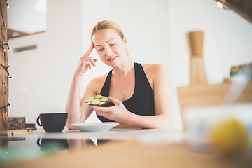 Image showing Beautiful sporty fit young pregnant woman having a healthy snack in home kitchen. Healty lifestyle concept.