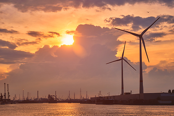 Image showing Wind turbines in Antwerp port on sunset.