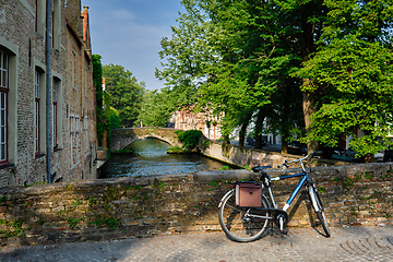 Image showing Bicyccle on a bridge near canal and old houses. Bruges Brugge , Belgium