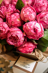 Image showing Bouquet of peony roses with letter and note saying - I love you.