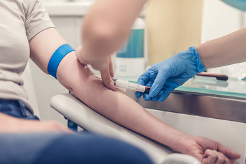 Image showing Close-up Of Doctor Taking Blood Sample From Patient's Arm in Hospital for Medical Testing.