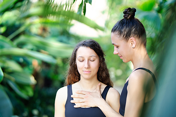 Image showing Yoga concept, meditation and sound therapy. Beautiful young girl at yoga session with her yoga and meditation teacher at tropical yoga retrear