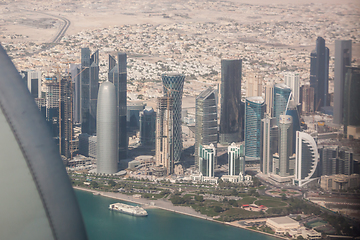 Image showing Aerial view of Doha through plane window, capital of Qatar in the Persian Gulf