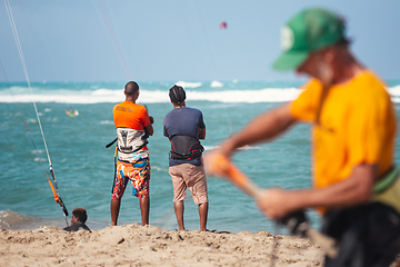 Image showing Active sporty people enjoying kitesurfing holidays and activities on perfect sunny day on Cabarete tropical sandy beach in Dominican Republic.