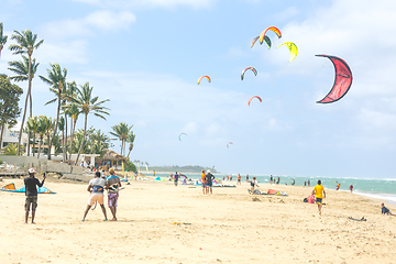 Image showing Crowd of active sporty people enjoying kitesurfing holidays and activities on perfect sunny day on Cabarete tropical sandy beach in Dominican Republic.