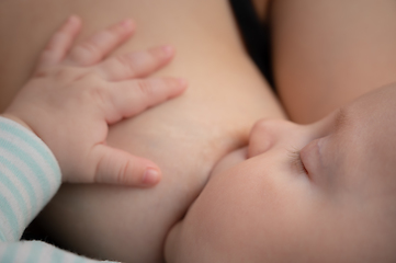 Image showing Newborn baby sucks mother's breast