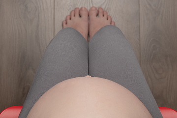 Image showing Pregnant woman sitting on chair - top view