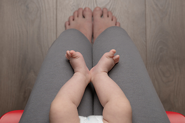 Image showing Woman sitting on chair with baby - top view