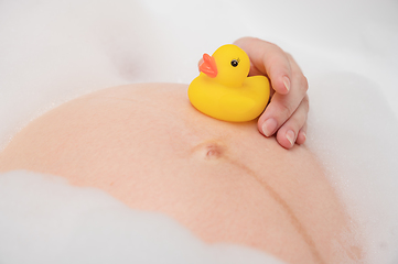 Image showing Pregnant woman in bath with toy