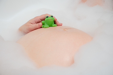 Image showing Pregnant woman in bath with toy