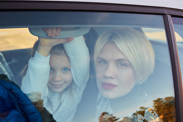 Image showing Family concept. Portrait of mother and daughter through the glass of a car