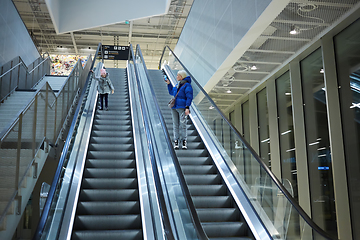 Image showing Mother and child together on escalator background. Terminal, air