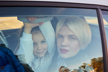 Image showing Family concept. Portrait of mother and daughter through the glass of a car