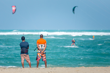 Image showing Active sporty people enjoying kitesurfing holidays and activities on perfect sunny day on Cabarete tropical sandy beach in Dominican Republic.