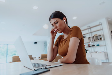 Image showing Woman sitting in living room using laptop look at cam talk by video call with business friend relatives, head shot. Job interview answering questions.