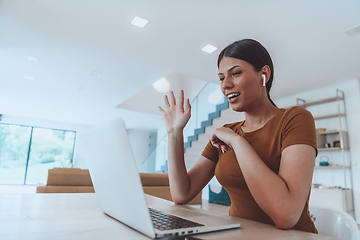 Image showing Woman sitting in living room using laptop look at cam talk by video call with business friend relatives, head shot. Job interview answering questions.