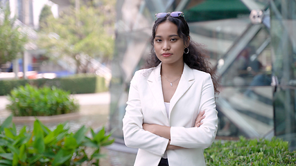 Image showing Elegant Asian Woman in Spring Suit Standing with Arms Crossed