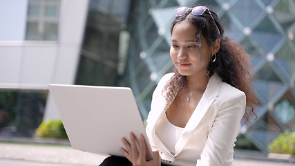 Image showing Portrait of young asian businesswoman working on laptop