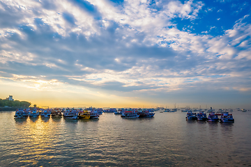 Image showing Tourist boats in sea on sunrise in Mumbai, India