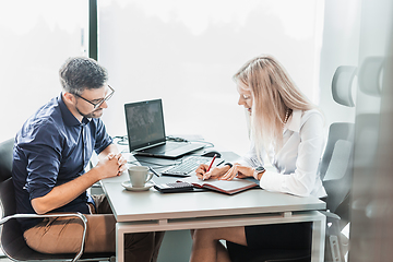 Image showing Business meeting. Client consulting. Confident business woman, real estate agent, financial advisor explaining details of project or financial product to client in office.