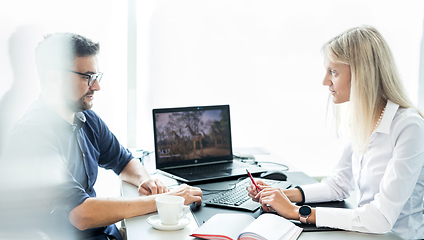 Image showing Business meeting. Client consulting. Confident business woman, real estate agent, financial advisor explaining details of project or financial product to client in office.