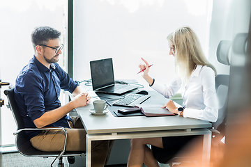 Image showing Business meeting. Client consulting. Confident business woman, real estate agent, financial advisor explaining details of project or financial product to client in office.