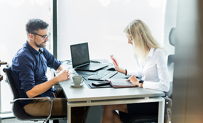 Image showing Business meeting. Client consulting. Confident business woman, real estate agent, financial advisor explaining details of project or financial product to client in office.