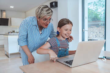 Image showing Mother with her daughter talking on laptop with family and friends while sitting in modern living room of big house