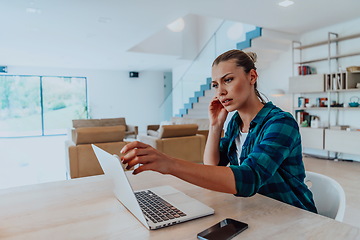 Image showing Woman sitting in living room using laptop look at cam talk by video call with business friend relatives, head shot. Job interview answering questions.